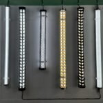 Decorative industrial LED tubular lights with metal mesh covers in gold, black, and silver – architectural tube lights for commercial interior lighting display