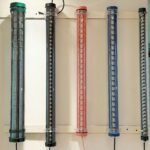 Colored LED tubular lights with louver-style internal reflectors – decorative industrial tube lighting for architectural and commercial interiors