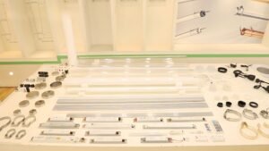 Complete component layout of LED tubular lights including transparent and frosted PC/PMMA tubes, aluminum profiles, end caps, mounting brackets, sealing parts, and LED drivers