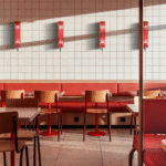 Restaurant interior with wall-mounted red architectural tubular LED lights providing decorative ambient lighting