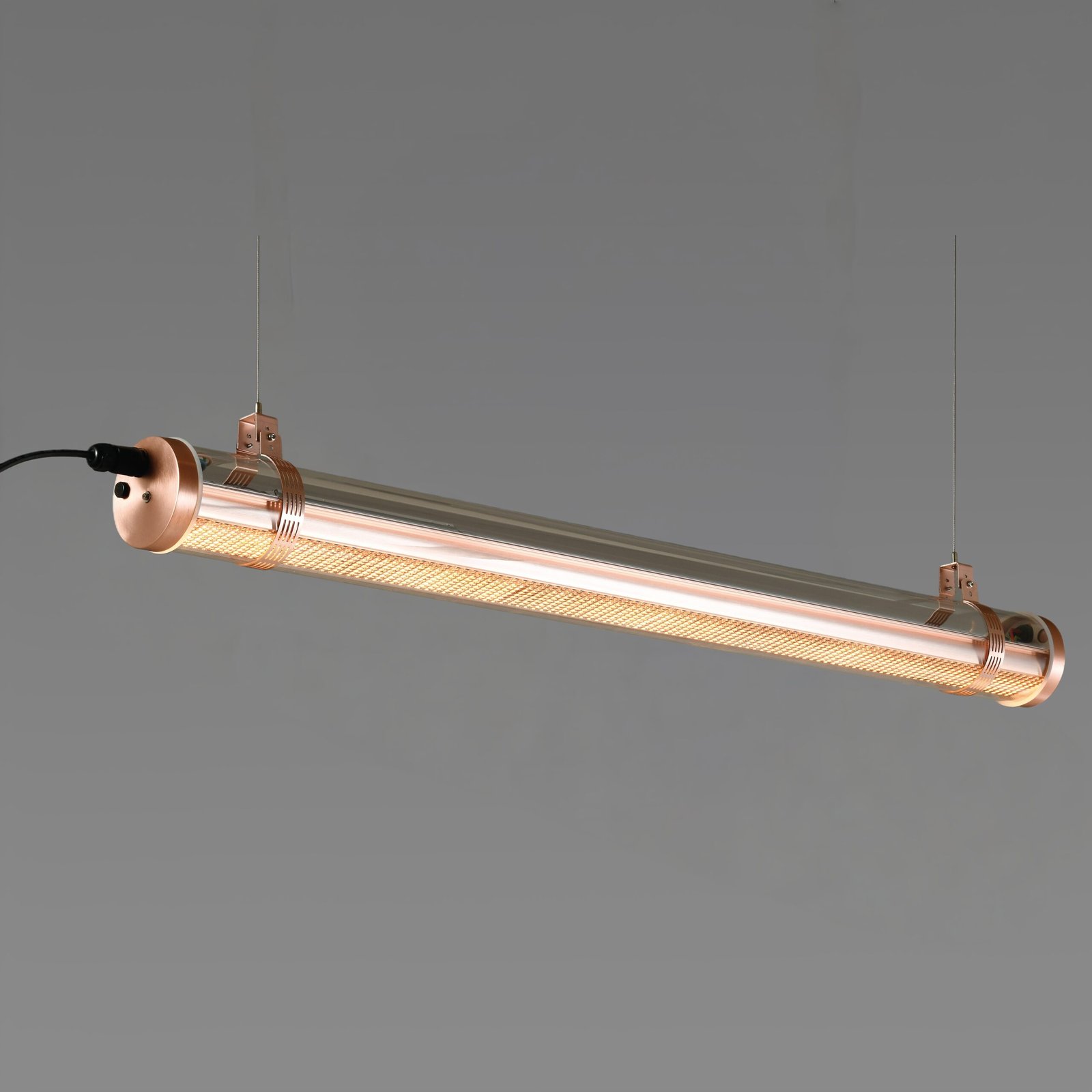 Titan Architectural Tubular Luminaire Titan architectural tubular luminaire with integrated honeycomb optic, suspended installation, warm brass-toned metal finish