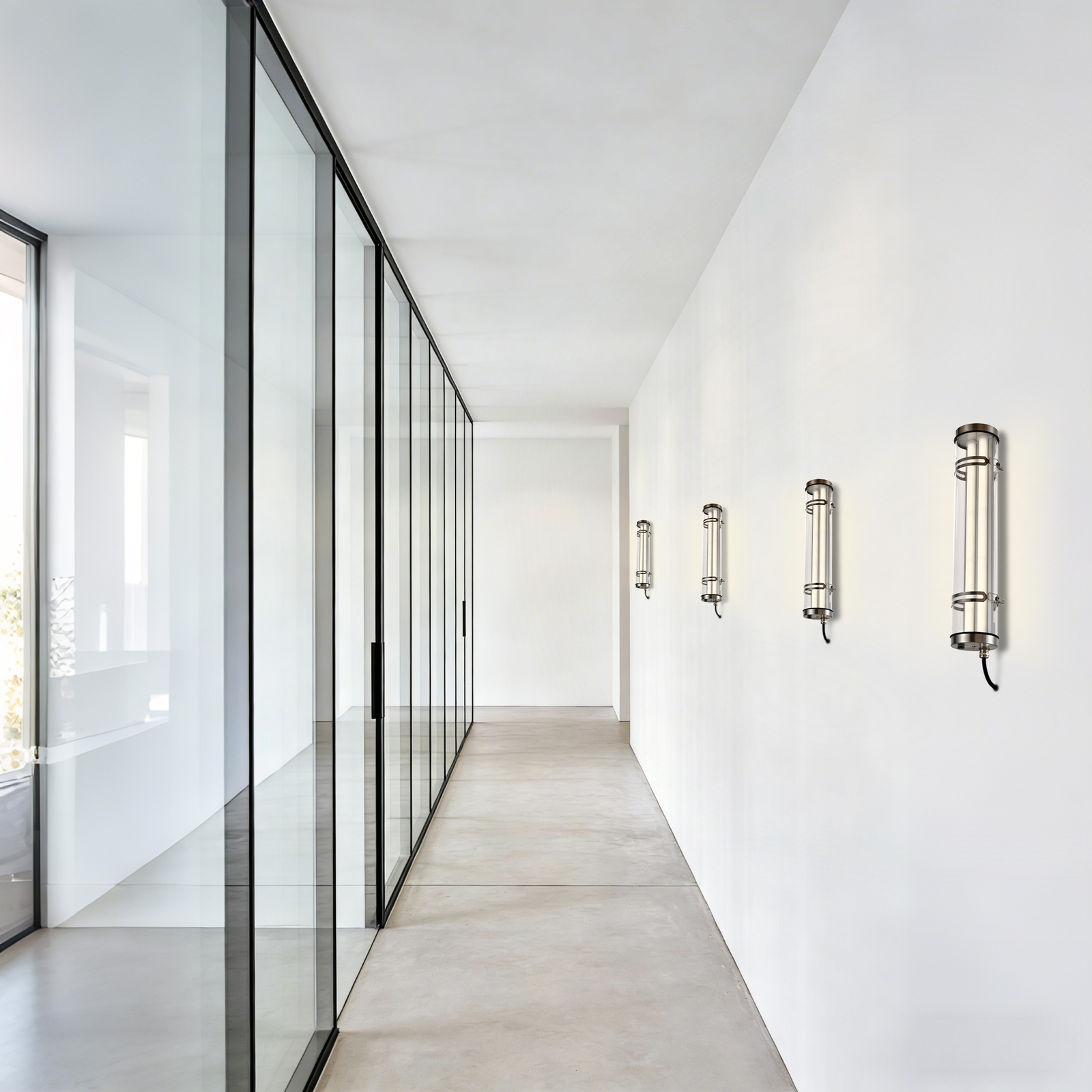 Wall-mounted and suspended installation tubular luminaires installed on a residential building façade, demonstrating clean, project-ready outdoor lighting application