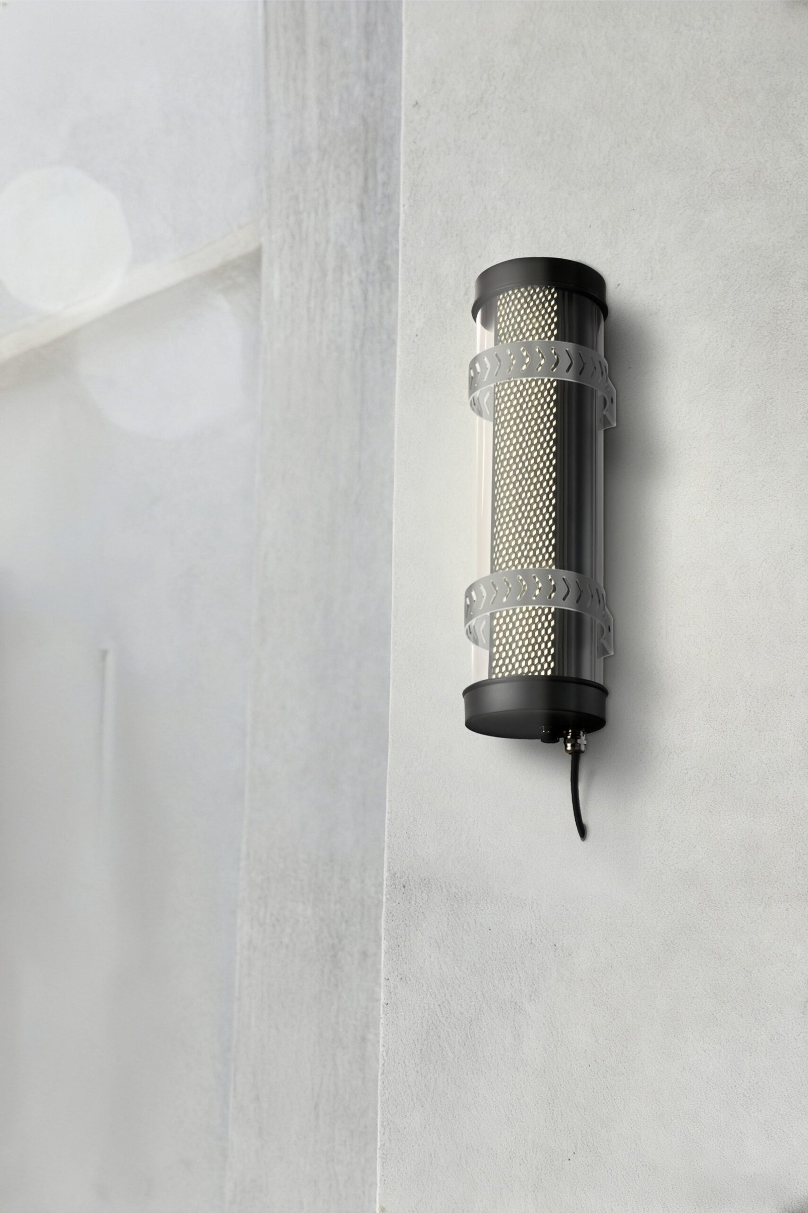 Arno Architectural Tubular Luminaire Arno IP67 IK10 architectural tubular wall lights installed on an outdoor building façade for long-term weather-resistant lighting