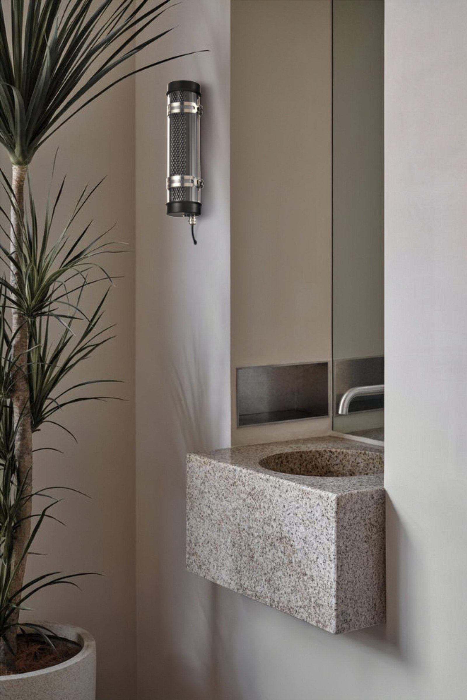 Arno Architectural Tubular Luminaire Arno IP67 IK10 architectural tubular wall lights installed on an outdoor building façade for long-term weather-resistant lighting