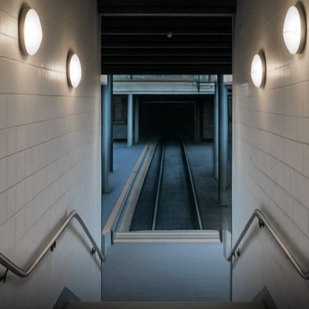 Home IP65 IK10 LED ceiling lights installed in underground transit corridor, providing uniform and durable lighting for public infrastructure